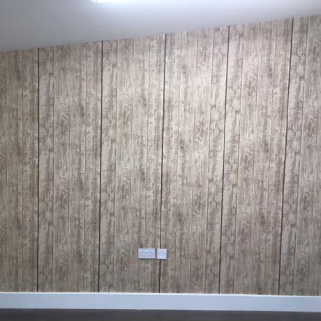 A room with smooth lavender walls and freshly painted white woodwork on the door frame and skirting. The high-quality finish demonstrates expert decorating services available in Islington, Covent Garden, and Canary Wharf.