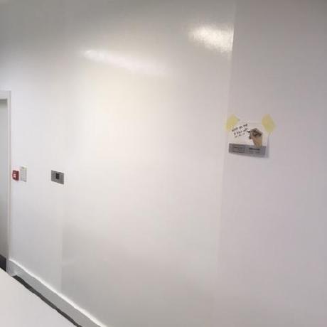 A functional office wall finished with high-gloss whiteboard paint for write-on use. Specialist commercial decorating and painting provided to businesses in Canary Wharf and Islington.