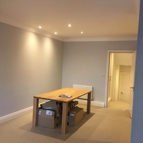 A room featuring lavender painted walls with clean white woodwork on the door frame and skirting boards. The high-quality finish highlights professional decorating services available in Islington, Covent Garden, and Canary Wharf.